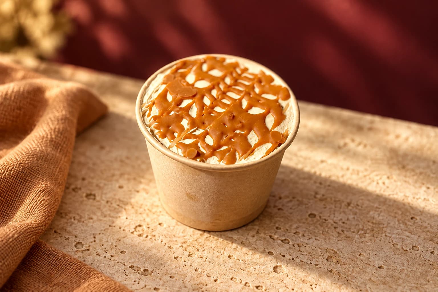 Tres Leches Lotus Biscoff dessert in a kraft cup with cream and caramel drizzle